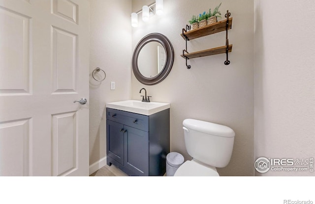 half bath with vanity and toilet