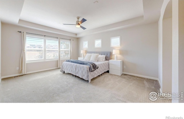 bedroom with carpet floors, multiple windows, and baseboards