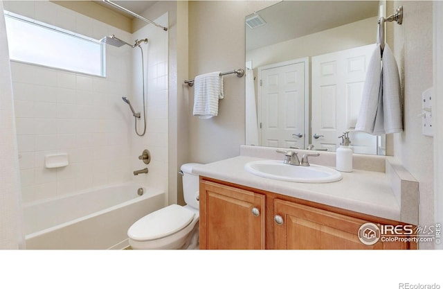 bathroom with toilet, visible vents,  shower combination, and vanity