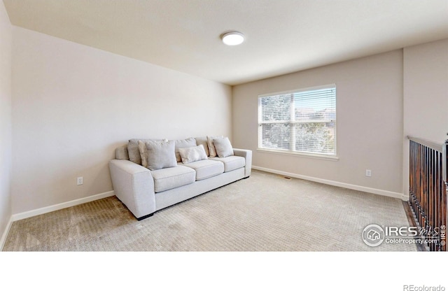 living room featuring carpet flooring and baseboards