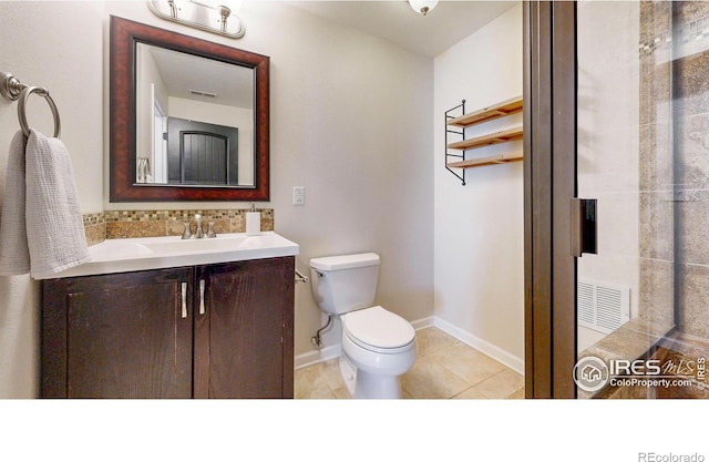 bathroom featuring visible vents, toilet, vanity, tile patterned flooring, and baseboards