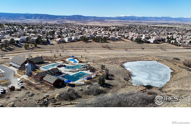 drone / aerial view featuring a residential view and a mountain view