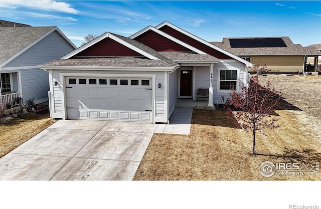 ranch-style home featuring a garage, driveway, and roof with shingles