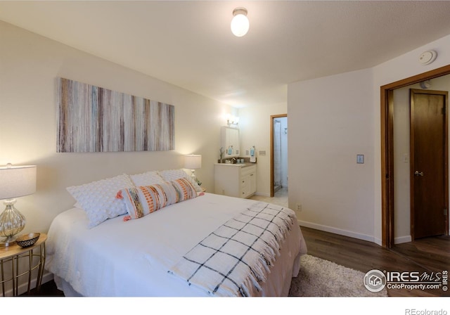 bedroom featuring baseboards and wood finished floors