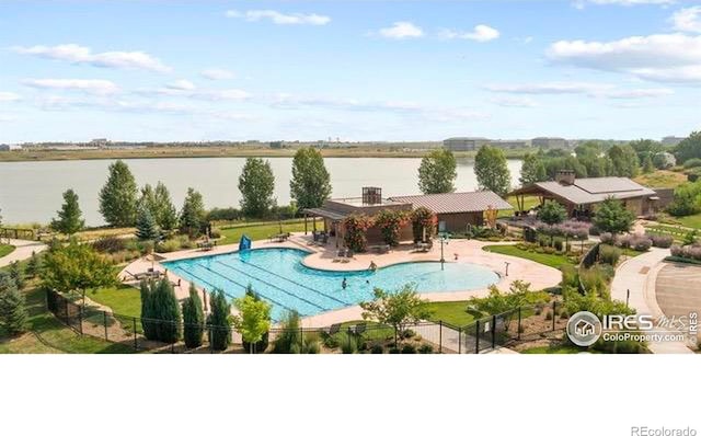 4110 S Park Dr, Loveland, CO 80538 - pool featuring a water view, a patio area, and fence