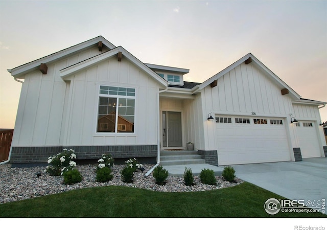 view of front of property with a garage, concrete driveway, and board and batten siding