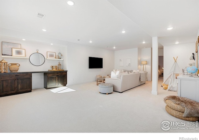 living area featuring carpet, visible vents, and recessed lighting