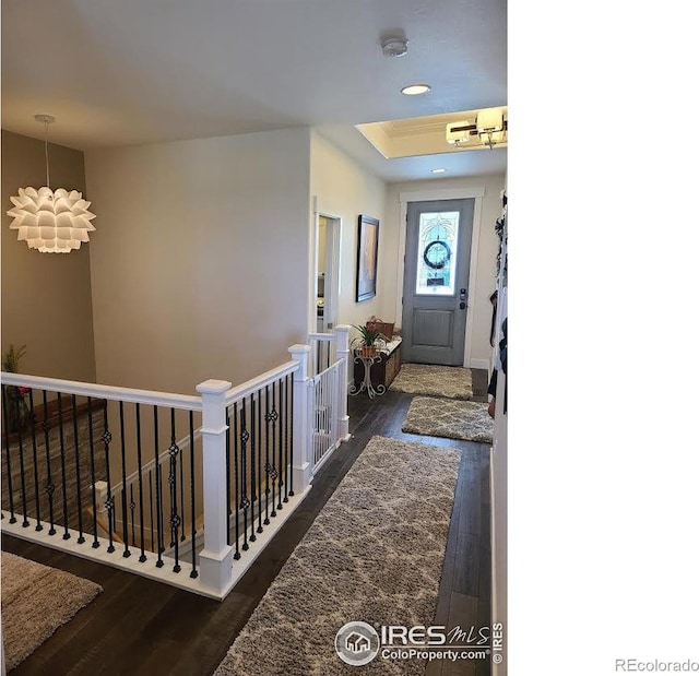 foyer featuring recessed lighting, dark wood-style flooring, and a raised ceiling