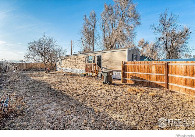 back of house with a fenced backyard