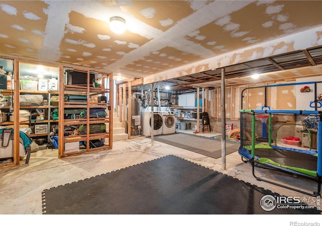 unfinished basement featuring gas water heater and separate washer and dryer