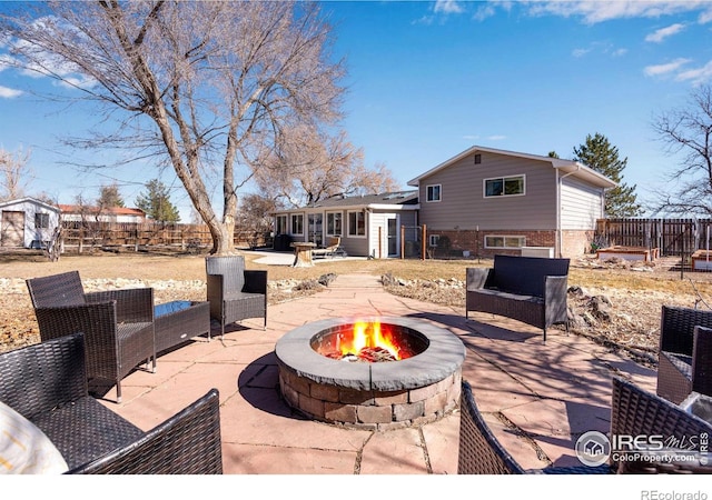 view of patio / terrace with an outdoor fire pit and a fenced backyard