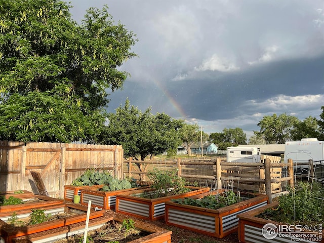 exterior space featuring a garden and fence