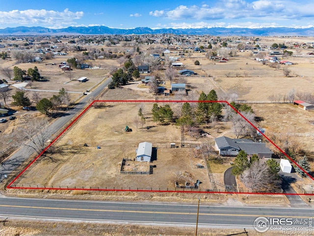 birds eye view of property with a rural view, a mountain view, and view of desert