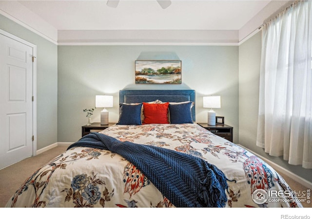 carpeted bedroom with baseboards and a ceiling fan