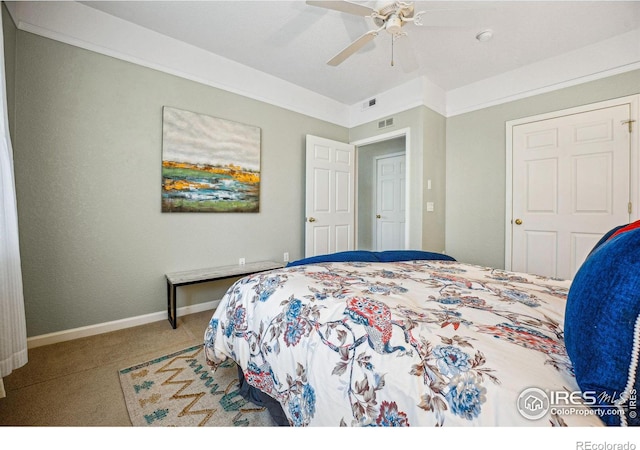 bedroom with carpet flooring, ceiling fan, visible vents, and baseboards