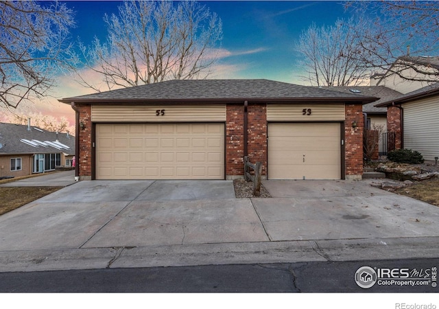 garage featuring concrete driveway