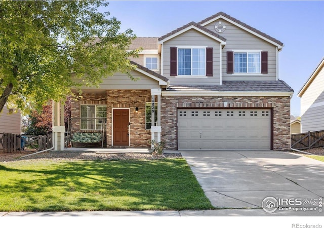 view of front of home with concrete driveway, brick siding, and fence