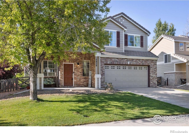 view of front of property featuring driveway, brick siding, an attached garage, fence, and a front yard