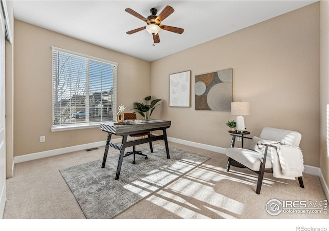 home office featuring carpet floors, visible vents, ceiling fan, and baseboards