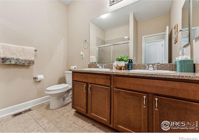 full bathroom featuring toilet, a stall shower, a sink, and visible vents