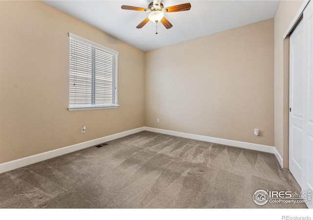 unfurnished room with visible vents, carpet flooring, a ceiling fan, and baseboards