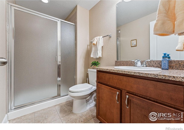 full bath featuring toilet, a stall shower, tile patterned flooring, and vanity