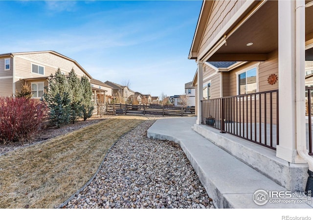 view of yard with a residential view and fence