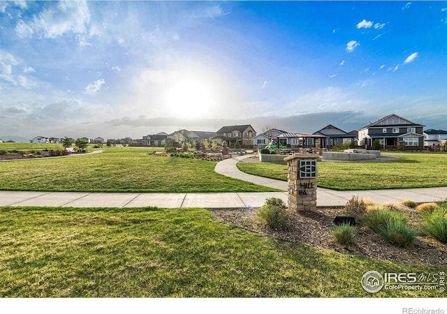 view of property's community with a residential view and a yard