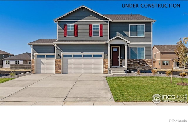 view of front of property featuring stone siding, concrete driveway, and a front yard