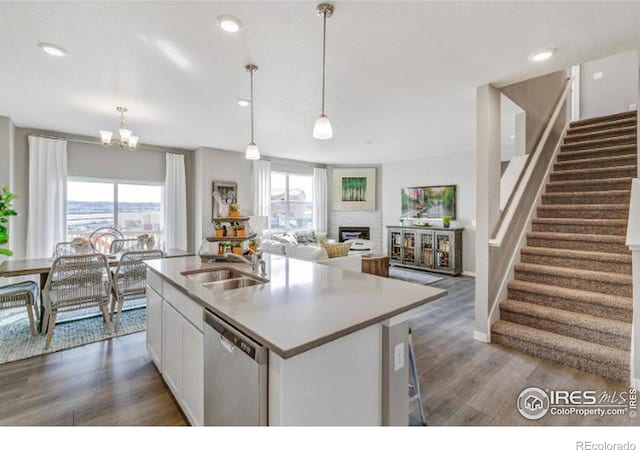 kitchen with a wealth of natural light, white cabinetry, a sink, and stainless steel dishwasher