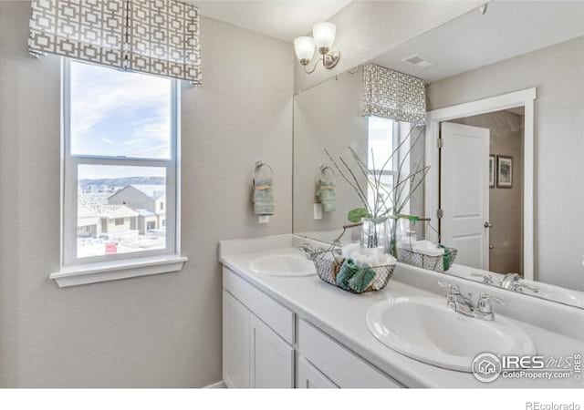 full bath with a sink and double vanity