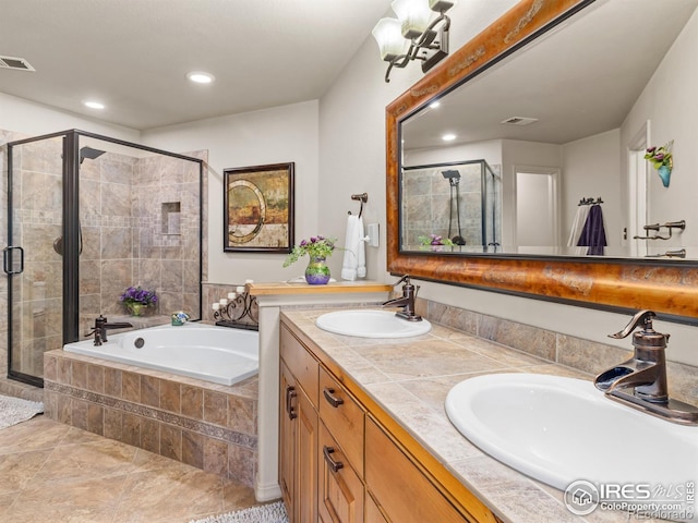 bathroom featuring a stall shower, visible vents, and a sink