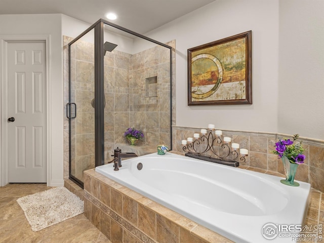 full bathroom with recessed lighting, a garden tub, and a shower stall