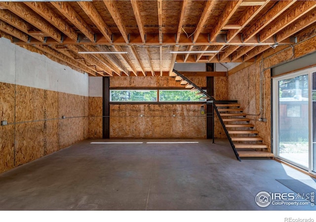 basement featuring plenty of natural light and stairway