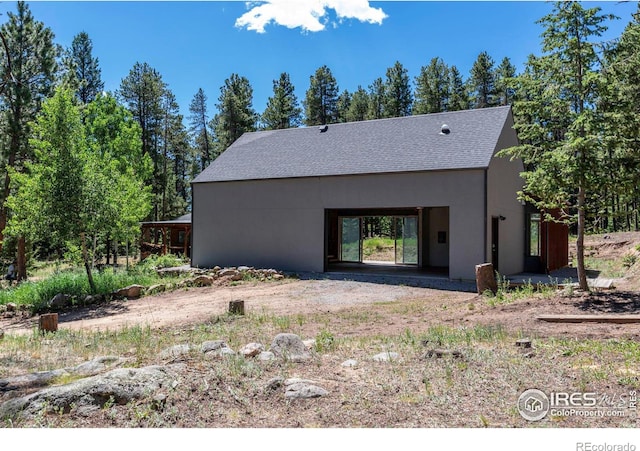 back of house with stucco siding