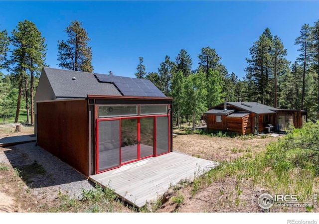 view of outdoor structure featuring solar panels