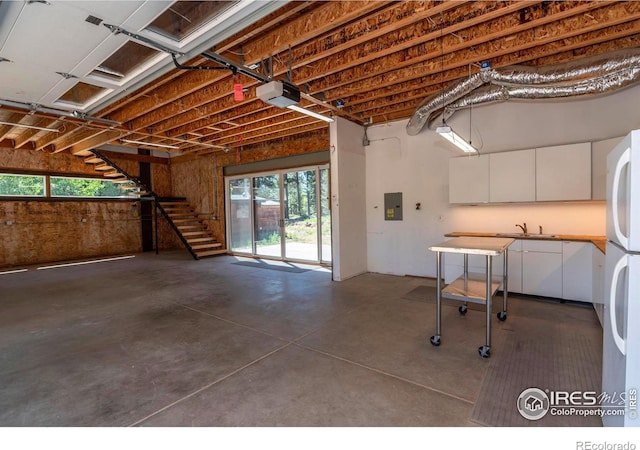 basement with electric panel and a sink