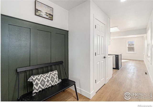 interior space featuring light wood-style flooring and baseboards