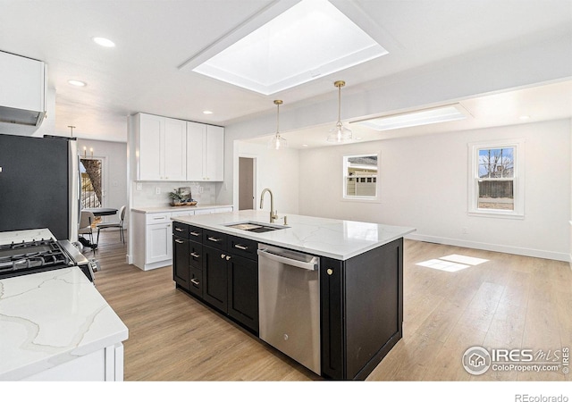 kitchen with a sink, a healthy amount of sunlight, appliances with stainless steel finishes, and dark cabinets