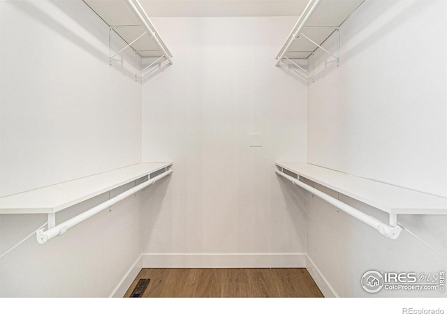 spacious closet with visible vents and wood finished floors