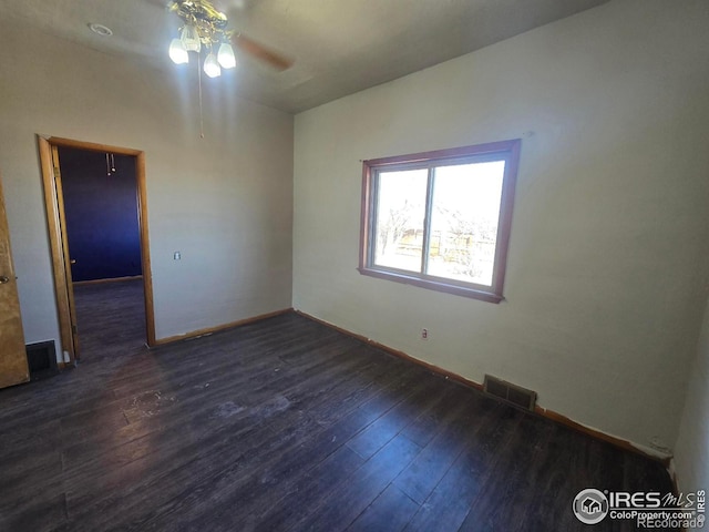 unfurnished room featuring visible vents, hardwood / wood-style flooring, and baseboards