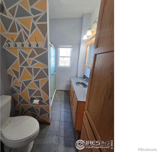 bathroom with vanity, toilet, and a shower stall