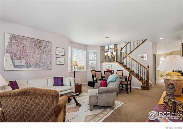 living room with carpet floors, a chandelier, stairway, and baseboards