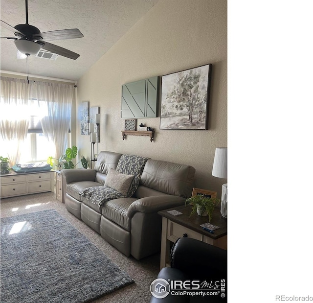 carpeted living area with a textured ceiling, a textured wall, ceiling fan, lofted ceiling, and visible vents