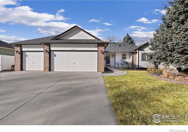 ranch-style house with a garage, concrete driveway, brick siding, and a front yard