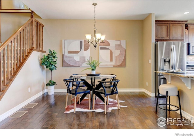 dining area with dark wood-style floors, a notable chandelier, visible vents, baseboards, and stairs