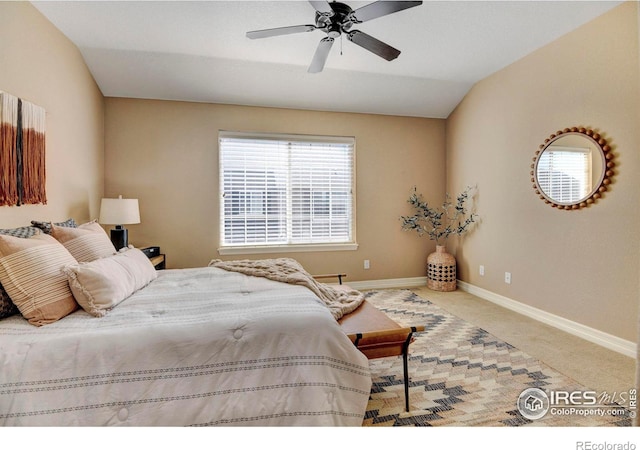 bedroom featuring a ceiling fan, lofted ceiling, carpet flooring, and baseboards