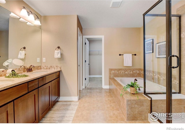 full bath with double vanity, visible vents, a sink, a shower stall, and a bath