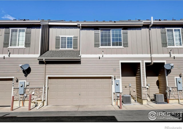 view of property featuring central AC and an attached garage