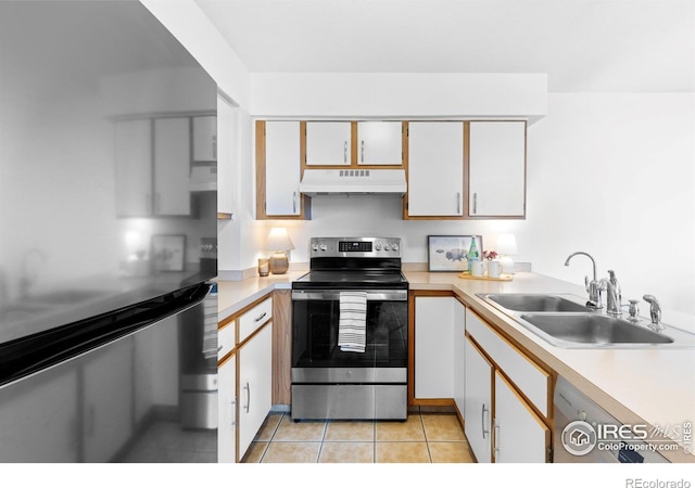 kitchen with light tile patterned floors, stainless steel appliances, light countertops, a sink, and under cabinet range hood